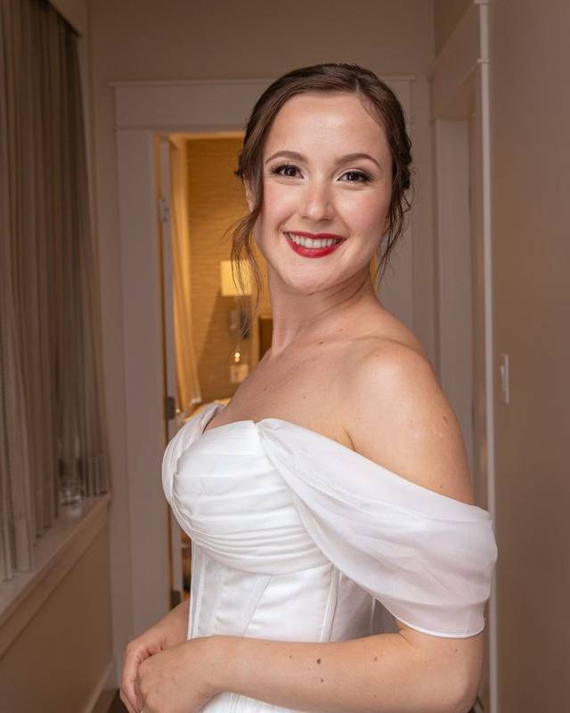 Smiling bride in an off-the-shoulder gown